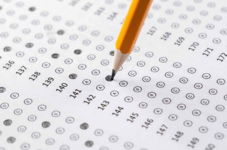 What are the benefits of standardized examinations in education?